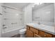 Bright bathroom featuring a vanity with wood cabinets and a shower-tub combination at 1329 Paradise Dr, Lady Lake, FL 32159