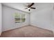 Bedroom featuring carpet flooring, large window, and ceiling fan at 1329 Paradise Dr, Lady Lake, FL 32159