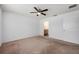Bedroom with a ceiling fan, neutral walls, and a view into an attached bathroom at 1329 Paradise Dr, Lady Lake, FL 32159