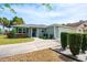 Charming home with well-maintained landscaping, driveway, and a welcoming entrance at 1329 Paradise Dr, Lady Lake, FL 32159