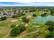 Scenic view of the meticulously kept golf course surrounded by mature trees and a tranquil lake at 1329 Paradise Dr, Lady Lake, FL 32159