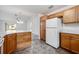Efficient kitchen layout with wooden cabinetry, white appliances, and an adjacent breakfast nook for casual dining at 1329 Paradise Dr, Lady Lake, FL 32159