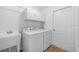 Functional laundry room equipped with a washer, dryer, and sink at 1329 Paradise Dr, Lady Lake, FL 32159