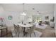 Bright living room with neutral tones, carpeted floors, and an adjacent dining area, ideal for hosting gatherings at 1329 Paradise Dr, Lady Lake, FL 32159