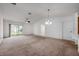 Bright living room with neutral carpet, ceiling fan, and sliding door access to the outdoors at 1329 Paradise Dr, Lady Lake, FL 32159