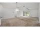 Spacious living room featuring neutral carpet and ceiling fan, creating a comfortable atmosphere at 1329 Paradise Dr, Lady Lake, FL 32159