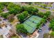 Aerial view of well-maintained tennis courts nestled among lush greenery and convenient parking at 1329 Paradise Dr, Lady Lake, FL 32159