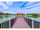 Scenic water view of a gazebo and a tranquil lake, ideal for relaxation and recreation at 1329 Paradise Dr, Lady Lake, FL 32159