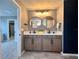 Modern bathroom with dual sinks, round mirrors, and stylish vanity lighting at 14533 Orchid Island Dr, Orlando, FL 32827