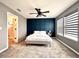 Cozy bedroom with modern accent wall, carpet, large windows and ceiling fan at 14533 Orchid Island Dr, Orlando, FL 32827