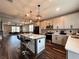 Open kitchen features modern pendant lighting, stainless steel appliances, and a stylish island with bar seating at 14533 Orchid Island Dr, Orlando, FL 32827