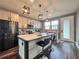 Modern kitchen features an island with seating, stainless steel appliances, and stylish pendant lighting at 14533 Orchid Island Dr, Orlando, FL 32827