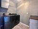 Laundry room featuring modern washer and dryer, gray walls, neutral floors, and functional storage solutions at 14533 Orchid Island Dr, Orlando, FL 32827