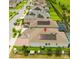 A home's aerial view featuring solar panels, a screened-in pool, manicured lawn, and paved driveway at 14711 Winter Stay Dr, Winter Garden, FL 34787