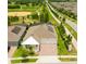 Beautiful aerial view of a home with solar panels in a golf community with a three-car garage and brick paved driveway at 14711 Winter Stay Dr, Winter Garden, FL 34787