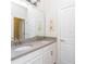 Well-lit bathroom features double sinks, a large mirror, and sleek hardware at 14711 Winter Stay Dr, Winter Garden, FL 34787