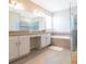 Modern bathroom featuring a tub, walk-in shower, and double vanity sinks at 14711 Winter Stay Dr, Winter Garden, FL 34787