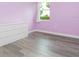 This bedroom features laminated flooring and a window view of lush greenery at 14711 Winter Stay Dr, Winter Garden, FL 34787