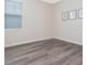 A bedroom features modern vinyl flooring, a large window, and stylish decor at 14711 Winter Stay Dr, Winter Garden, FL 34787