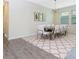 Dining room with large table, white chairs, and an eye-catching light fixture creates an elegant space at 14711 Winter Stay Dr, Winter Garden, FL 34787