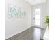 This entryway has a modern white front door with glass panels and stylish botanical wall art at 14711 Winter Stay Dr, Winter Garden, FL 34787
