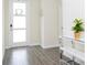 Inviting entryway with modern console table, decorative plant, and tiled floors at 14711 Winter Stay Dr, Winter Garden, FL 34787