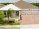 A gorgeous home's exterior featuring a covered porch, three-car garage, paved driveway, and manicured lawn at 14711 Winter Stay Dr, Winter Garden, FL 34787