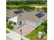 A beautiful home's exterior featuring solar panels, a brick paved driveway, a covered entryway, and a manicured lawn at 14711 Winter Stay Dr, Winter Garden, FL 34787