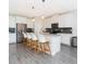 This modern kitchen offers an island with seating, pendant lighting, and stainless steel appliances at 14711 Winter Stay Dr, Winter Garden, FL 34787