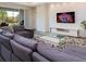 This modern living room includes plush seating, a glass coffee table, and a sleek entertainment center at 14711 Winter Stay Dr, Winter Garden, FL 34787