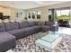 Cozy living room featuring a large sectional sofa, modern glass coffee table, and an open floor plan at 14711 Winter Stay Dr, Winter Garden, FL 34787
