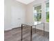 Bright office space featuring a glass desk, wood-look floors and double door closet at 14711 Winter Stay Dr, Winter Garden, FL 34787