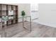 Stylish office space with wood-look flooring and glass desk; built-in shelves visible at 14711 Winter Stay Dr, Winter Garden, FL 34787