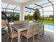 Relaxing patio features a dining area and a view of the sparkling pool at 14711 Winter Stay Dr, Winter Garden, FL 34787