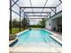 Gorgeous pool with tanning ledge and covered enclosure, seamlessly blending indoor and outdoor living at 14711 Winter Stay Dr, Winter Garden, FL 34787