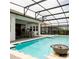 Inviting pool area with covered patio and outdoor dining space, perfect for entertaining at 14711 Winter Stay Dr, Winter Garden, FL 34787