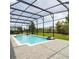 Relaxing screened-in pool with lush landscaping and plenty of patio space at 14711 Winter Stay Dr, Winter Garden, FL 34787