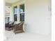 Inviting porch with cozy chairs and a small table offering a perfect spot for relaxation at 14711 Winter Stay Dr, Winter Garden, FL 34787