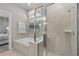 Bright bathroom with a soaking tub and separate glass shower for a spa-like experience at 16147 Coastal Cove Ln, Clermont, FL 34714