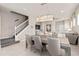 Stylish dining room with a modern chandelier, staircase, and views of the living room at 16147 Coastal Cove Ln, Clermont, FL 34714