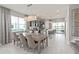Elegant dining area with a chandelier, seating for six, and a view of the kitchen at 16147 Coastal Cove Ln, Clermont, FL 34714