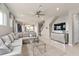 Open-concept living area with a large sofa, tile flooring, and a view of the dining area at 16147 Coastal Cove Ln, Clermont, FL 34714
