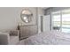 Relaxing main bedroom showcases a backyard view, dresser, and access to the outdoor patio at 16147 Coastal Cove Ln, Clermont, FL 34714