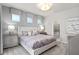 Comfortable bedroom with tufted headboard, soft lighting, and ensuite bath access at 16147 Coastal Cove Ln, Clermont, FL 34714