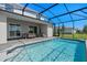A screened pool with clear water and outdoor seating, perfect for relaxation and enjoyment at 16147 Coastal Cove Ln, Clermont, FL 34714