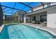 A sparkling screened pool with a patio for relaxing and entertaining on sunny days at 16147 Coastal Cove Ln, Clermont, FL 34714