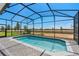 Inviting screened pool with a beautiful view of the surrounding landscape at 16147 Coastal Cove Ln, Clermont, FL 34714