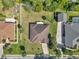 Aerial view of home with a spacious yard, mature trees, and a well-maintained roof with a clean landscape at 1819 Sw 29Th St, Ocala, FL 34471