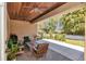 Spacious covered patio with wood ceiling, lounge area, grill, and a view of the well-maintained backyard at 1819 Sw 29Th St, Ocala, FL 34471