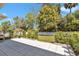 Large backyard features a concrete patio, mature landscaping, a white fence, and a well-manicured lawn at 1819 Sw 29Th St, Ocala, FL 34471